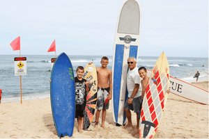 Steve Walden with grandkids surfing at Chuns
