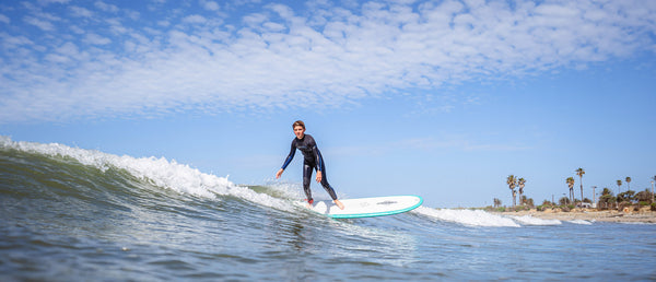 Young Teenage Boy Surfing Waves on a Micro Magic Walden Surfboard